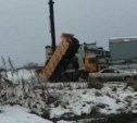 Самосвал в Поронайске выгрузил кузов грязного снега перед жилым домом