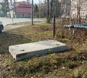 Опасный люк возле школы в Долинске прикрыли тяжёлой бетонной плитой