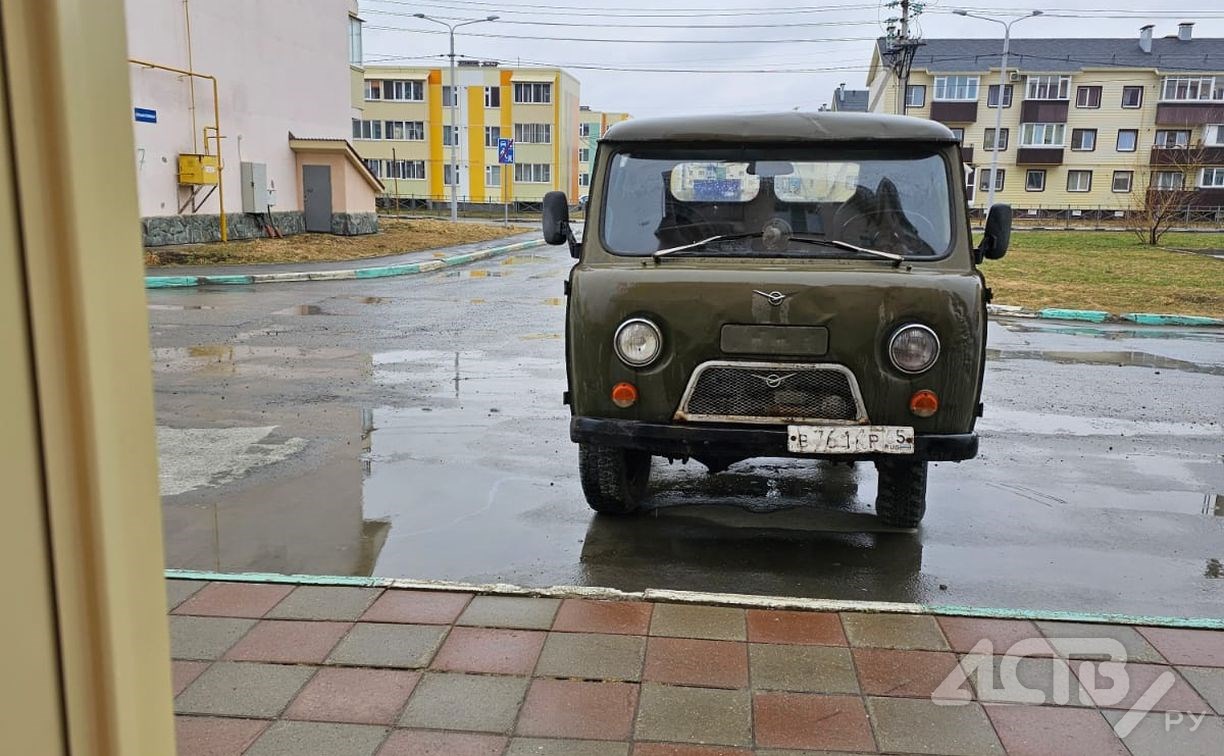 Южносахалинцы пытаются выгнать со двора "забытый"  автомобиль, из которого сочится масло